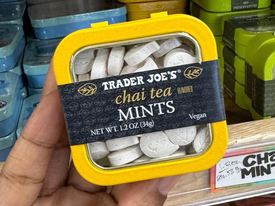 hand holding up a tin of chai tea mints at trader joes