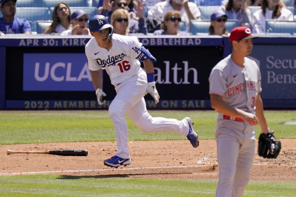 Los Angeles Dodgers' Will Smith, left, runs to first after hitting a two RBI double as Cincinnati Reds starting pitcher Tyler Mahle watches during the fourth inning of a baseball game Sunday, April 17, 2022, in Los Angeles. (AP Photo/Mark J. Terrill)