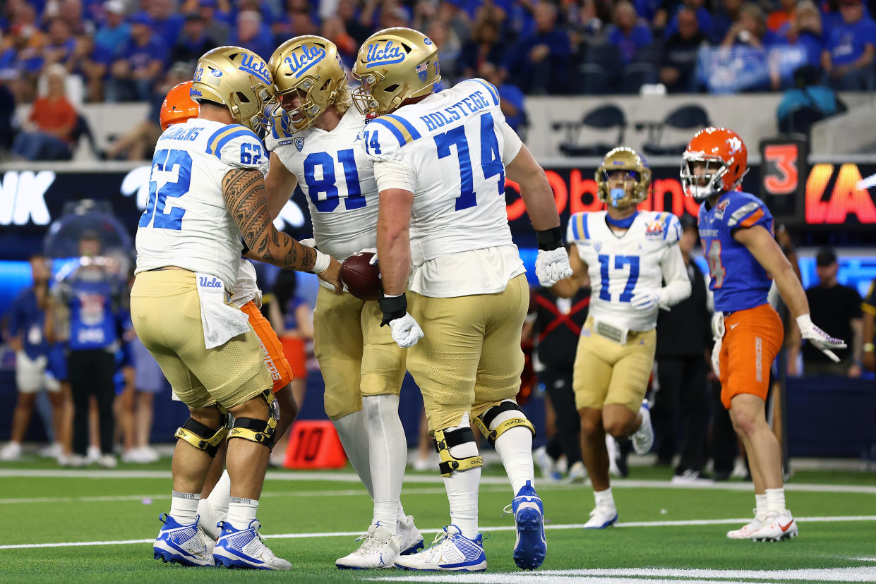 INGLEWOOD, CALIFORNIA - DECEMBER 16: Hudson Habermehl #81 of the UCLA Bruins celebrates a touchdown with teammates Duke Clemens #62 and Spencer Holstege #74 in the first quarter against the Boise State Broncos during the Starco Brands LA Bowl Hosted by Gronk at SoFi Stadium on December 16, 2023 in Inglewood, California. (Photo by Katelyn Mulcahy/Getty Images)