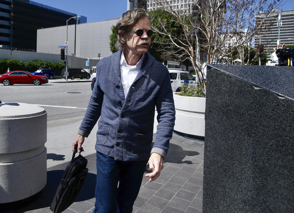 William H. Macy arrived in court Tuesday to support his wife, Felicity Huffman. According to court papers, he was aware of his wife’s involvement in the scam, but he has avoided an arrest at this point. (Photo: AP Images)