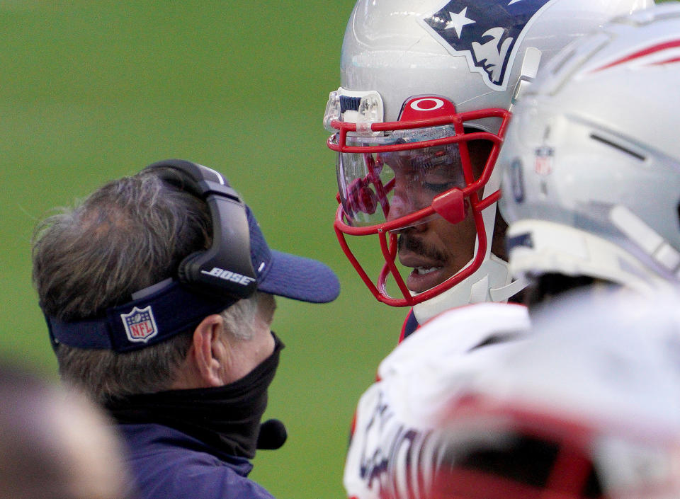 Head coach Bill Belichick and Cam Newton talk on the sideline against the Miami Dolphins.