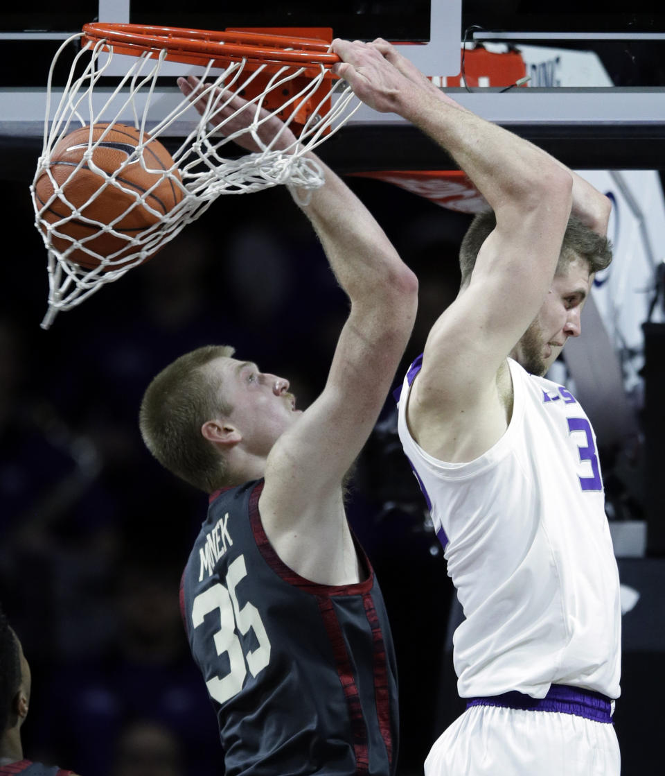 Kansas State forward Dean Wade, right, dunks behind his head over Oklahoma forward Brady Manek, left, during the first half of an NCAA college basketball game in Manhattan, Kan., Saturday, March 9, 2019. (AP Photo/Orlin Wagner)