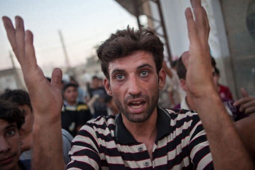 A resident of the Syrian village of Treimsa, where more than 150 people were killed this week, shouts slogans in the village in the central province of Hama on July 13. Syria's army blasted rebel strongholds in Damascus with mortars Sunday, sparking the "most intense" fighting in the capital since the revolt erupted 16 months ago, a monitoring group said