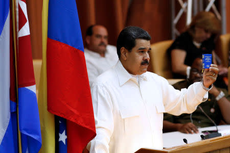 Venezuela's President Nicolas Maduro holds the Venezuela's constitution as he speaks during the XV Political Council of the Bolivarian Alliance for the Peoples of Our America - Peoples' Trade Treaty (ALBA-TCP) in Havana, Cuba, April 10, 2017. REUTERS/Stringer