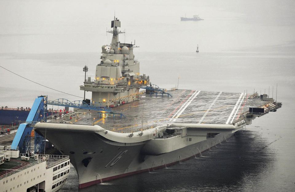 China's first aircraft carrier, which was renovated from an old aircraft carrier that China bought from Ukraine in 1998, is seen docked at Dalian Port, Liaoning province, in this September 22, 2012 file photo. A lack of detailed operational guidelines between the Chinese military and the United States and its allies is heightening fears that a miscalculation or mishap across Asia's crowded seas and skies could get out of control. When a U.S. guided missile cruiser shadowing China's only aircraft carrier in the South China Sea earlier this month was forced to change course to avoid hitting a smaller Chinese warship, it was seen as the latest sign of how dangerously closely the two navies now operate. REUTERS/Stringer/Files (CHINA - Tags: MILITARY POLITICS) CHINA OUT. NO COMMERCIAL OR EDITORIAL SALES IN CHINA
