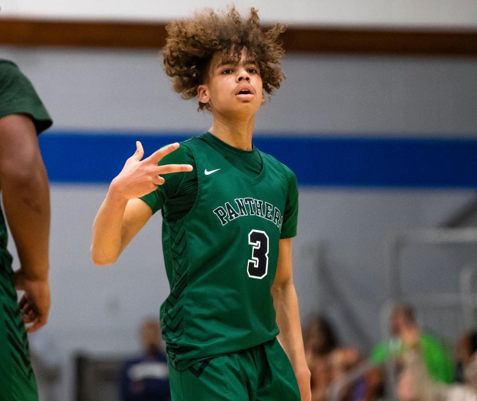 Washington's Steven Reynolds (3) celebrates during the Washington vs. Marian boys basketball game Friday, Jan. 27, 2023 at Marian High School.