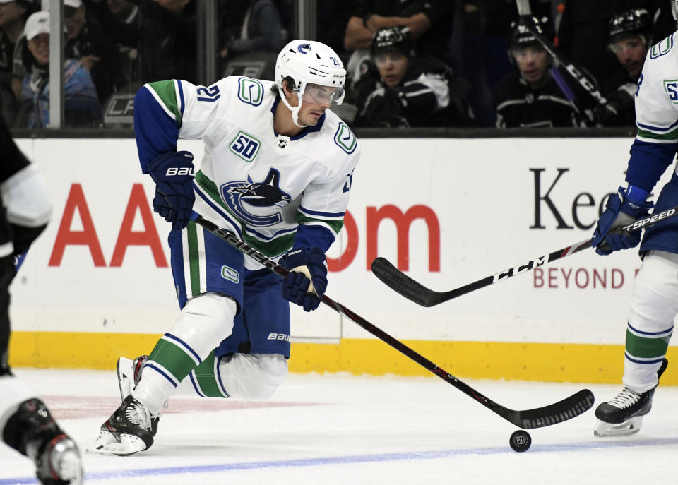 FILE - In this Oct. 30, 2019, file photo, Vancouver Canucks left wing Loui Eriksson, of Sweden, advances the puck during an NHL hockey game against the Los Angeles Kings in Los Angeles. NHL teams got a jumpstart on making trades in the hours before the first round of the draft. In a blockbuster deal, the Arizona Coyotes dealt captain Oliver Ekman-Larsson and restricted free agent forward Conor Garland to the Canucks for the No. 9 selection, two other picks and forwards Antoine Roussel, Jay Beagle and Eriksson. (AP Photo/Michael Owen Baker, File)