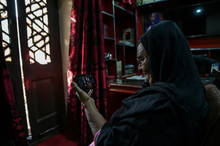 Former sex worker Shagufta watches the trailer of "Heeramandi" (Amna YASEEN)