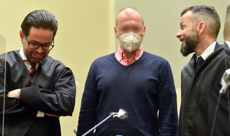 German sports doctor Mark S., accused of masterminding an international doping network in cycling and winter sports, speaks with his lawyers Alexander Dann and Yuri Goldstein as he waits for the verdict in his trial at the Regional Court in Munich