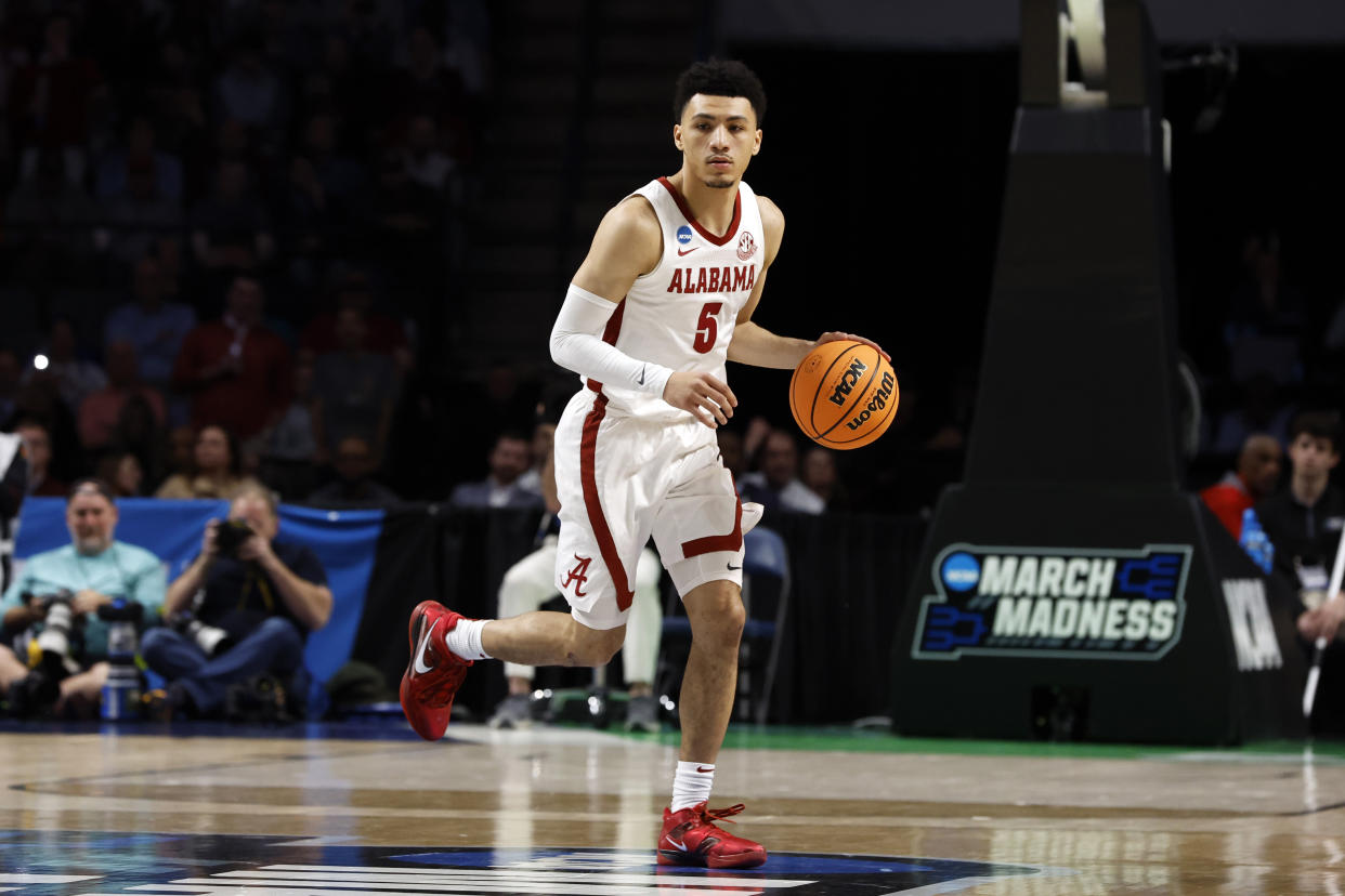 Alabama guard Jahvon Quinerly (5) dribbles the ball in the first half of a second-round college basketball game against Maryland in the NCAA Tournament in Birmingham, Ala., Saturday, March 18, 2023. (AP Photo/Butch Dill)
