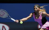 Serena Williams of the U.S. hits a return to Vesna Dolonc of Serbia during their women's singles match at the Australian Open 2014 tennis tournament in Melbourne January 15, 2014. REUTERS/Jason Reed