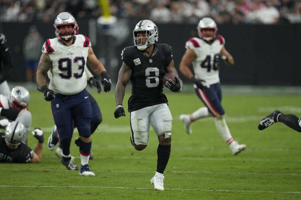 Las Vegas Raiders running back Josh Jacobs runs with the ball during the second half of an NFL football game against the New England Patriots, Sunday, Oct. 15, 2023, in Las Vegas. (AP Photo/John Locher)