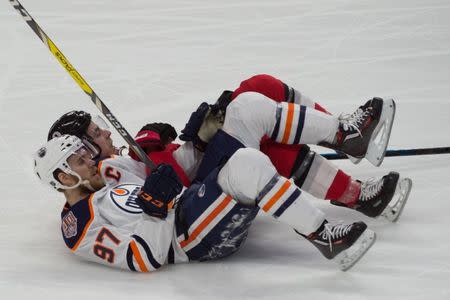Feb 28, 2019; Ottawa, Ontario, CAN; Edmonton Oilers center Connor McDavid (97) and Ottawa Senators center Jean-Gabriel Pageau (44) fall to the ice in the third period at the Canadian Tire Centre. Mandatory Credit: Marc DesRosiers-USA TODAY Sports