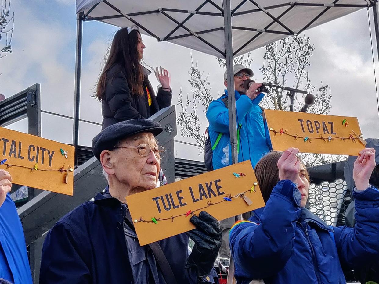 Homer Yasui holds a placard with the name of the camp where he was incarcerated during World War II, part of a protest Sunday in Tacoma, Washington, at a present-day immigrant detention center. (Photo: Mari Hayman/HuffPost)