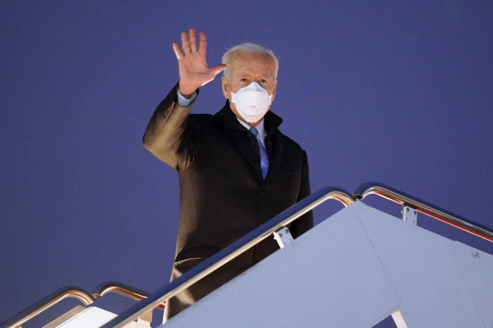 President Joe Biden waves before boarding Air Force One for a trip to Camp David, Friday, Feb. 12, 2021, in Andrews Air Force Base, Md. (AP Photo/Evan Vucci)
