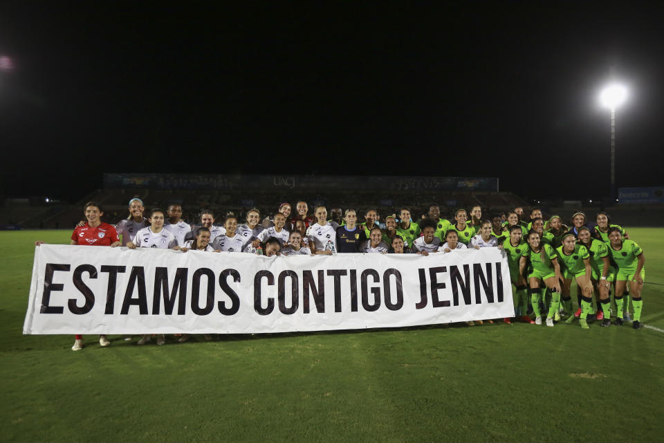 FILE - Players of the "Pachuca de Mexico" soccer team hold a banner reading in Spanish "we are with you Jenni", ahead of a match in Ciudad Juarez, Mexico on Friday, Aug. 25, 2023. The kiss by Luis Rubiales has unleashed a storm of fury over gender equality that almost marred the unprecedented victory but now looks set to go down as a milestone in both Spanish soccer history but also in women's rights. (AP Photo/Christian Chavez, file)