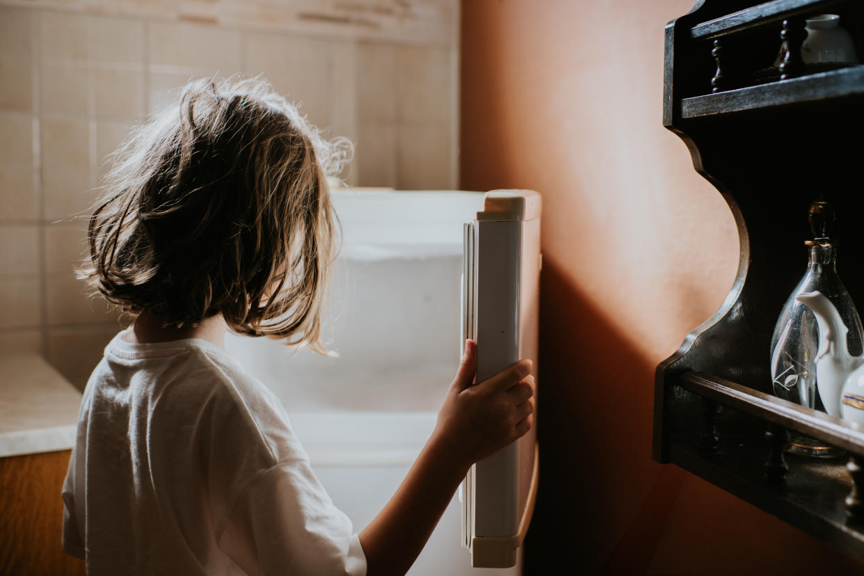 A child opening an empty fridge. (Getty Images)