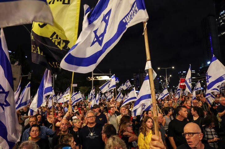 People attend a protest against Israeli Prime Minister Netanyahu's government and to call for the release of hostages, in Tel Aviv