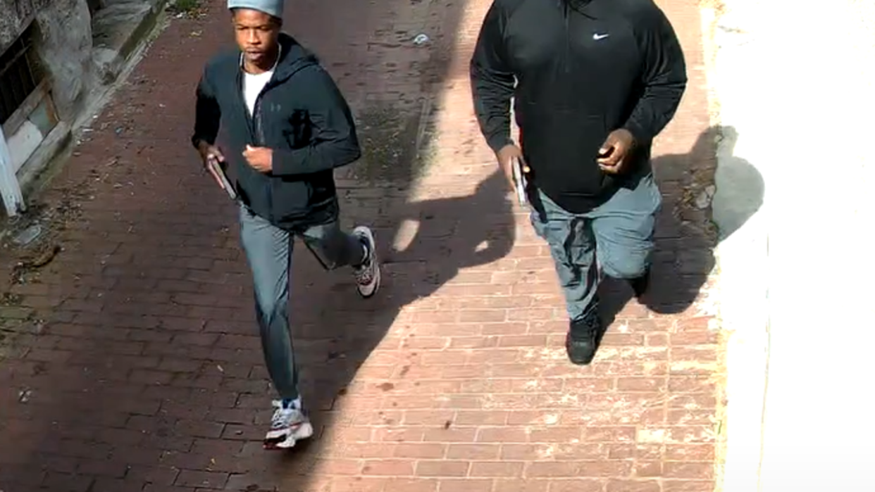 <div>Snapshot of the security camera footage which shows two gunmen running away from Friday's shooting near Dunbar High School.</div>