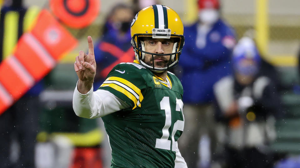 GREEN BAY, WISCONSIN - JANUARY 16: Aaron Rodgers #12 of the Green Bay Packers signals in the second quarter against the Los Angeles Rams during the NFC Divisional Playoff game at Lambeau Field on January 16, 2021 in Green Bay, Wisconsin. (Photo by Dylan Buell/Getty Images)