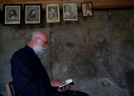 Hermit Stan Vanuytrecht of Belgium prays in his private chapel of the hermitage in Saalfelden, Austria, May 22, 2017. Picture taken May 22, 2017. REUTERS/Leonhard Foeger