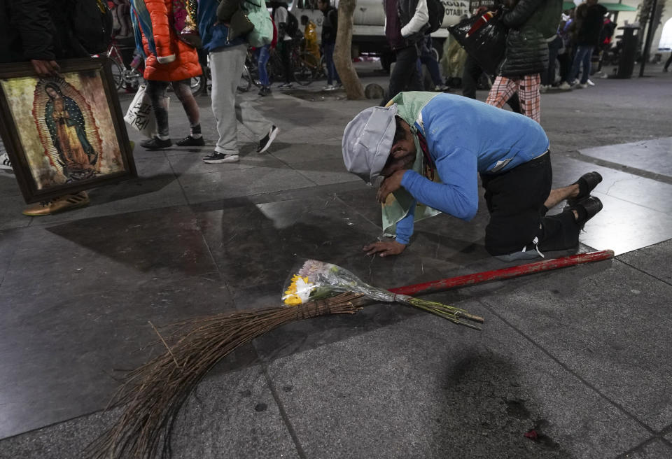 Chatito Salinas, a Cantinflas personator, cries on his knees as he makes his way to the Basilica of Guadalupe on her feast day in Mexico City, early Tuesday, Dec. 12, 2023. Salinas' wife explained that she suffered a miscarriage and that they came to ask the Virgin for another pregnancy. Devotees of Our Lady of Guadalupe gather for one of the world's largest religious pilgrimages on the anniversary of one of several apparitions of the Virgin Mary witnessed by an Indigenous Mexican man named Juan Diego in 1531. (AP Photo/Marco Ugarte)