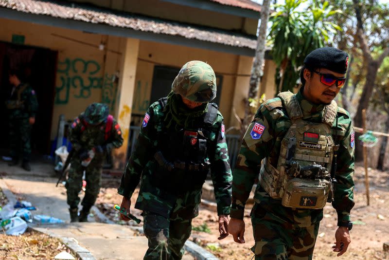 FILE PHOTO: LT Saw Kaw, a soldier of the Karen National Liberation Army (KNLA) , walks with his team members after inspecting the house of a high-rank Myanmar soldier at Infantry Batallion 275 at Myawaddy