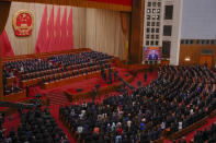 A screen shows Chinese President Xi Jinping as leaders and delegates stand for national anthem during the closing session of the National People's Congress (NPC) at the Great Hall of the People in Beijing, Monday, March 11, 2024. (AP Photo/Andy Wong)