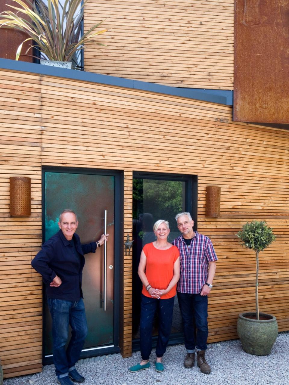 Kevin McCloud with Rob and Kate outside the completed home (Channel 4)