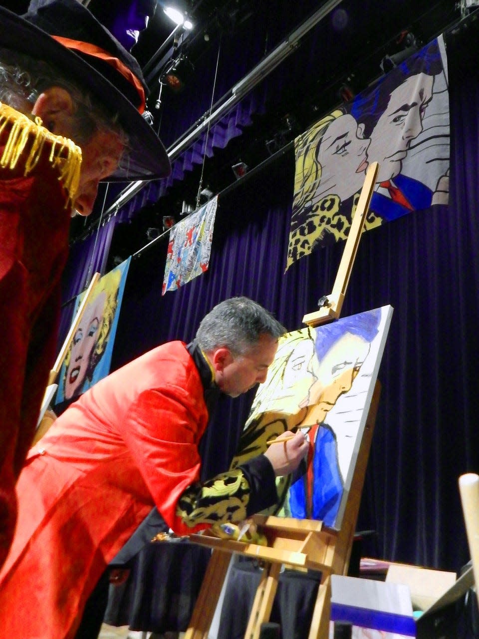 Great River Heath Foundation executive director Jason Hutcheson touches up his painting as his guru David Garrison looks on at the 2022 Celebrity Battle of the Brushes paint-off held at Burlington Memorial Auditorium on Friday, Nov. 18, 2022. Hutcheson's painting sold for $3,400 at the event to raise money for the Art Center of Burlington.