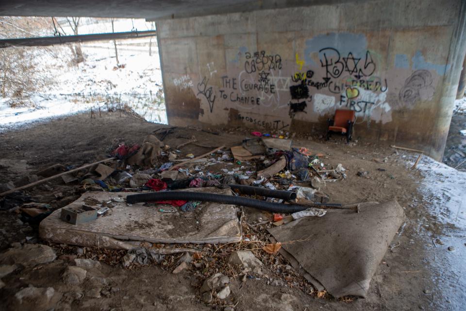A trashed mattress and other items were scattered under a bridge at S.W. Buchanan Street in 2021 as people seeking to count the city's homeless population look for places where they may be living. This area was known as a possible site of sex trafficking before a flood the previous year.