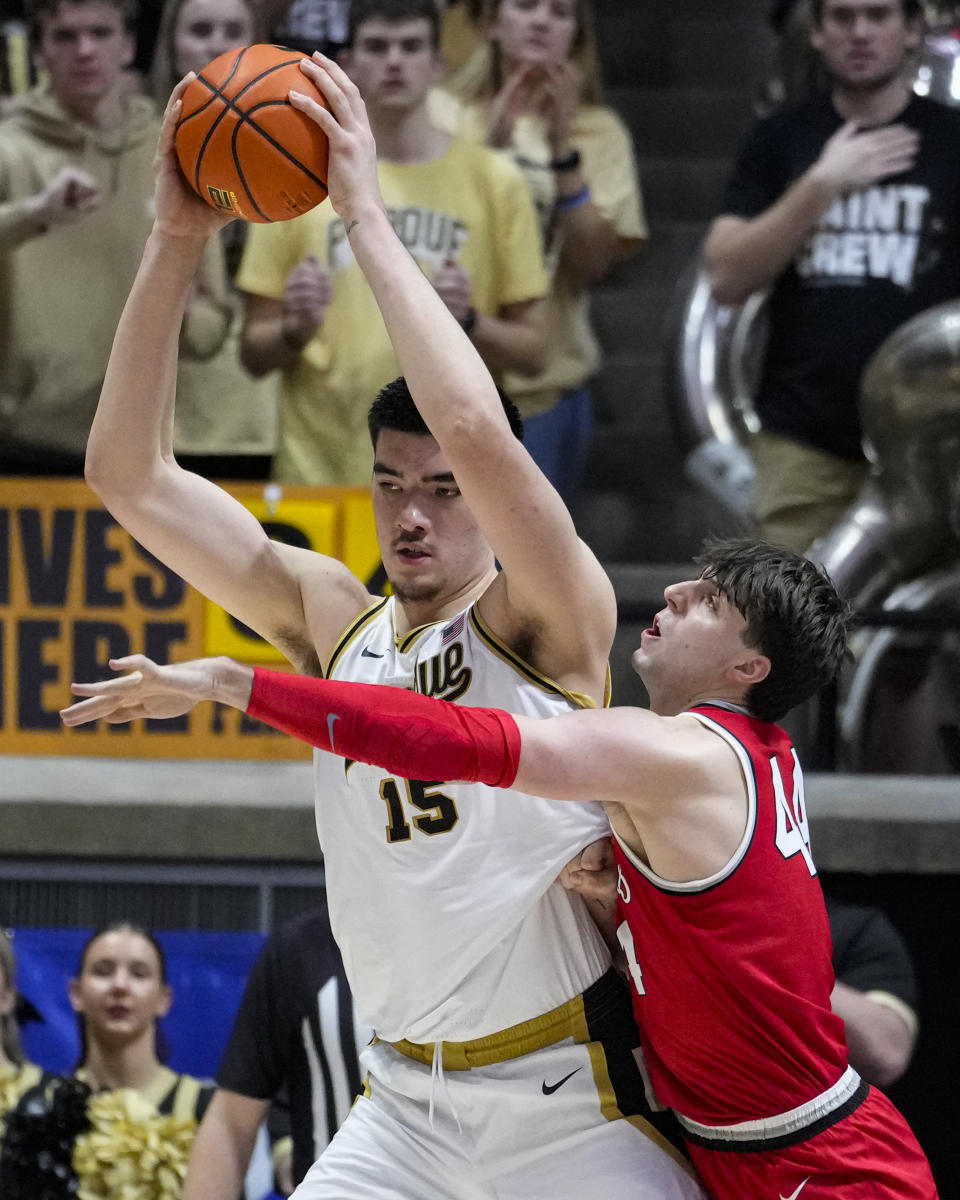 Ohio State forward Owen Spencer (44) defends Purdue center Zach Edey (15) in the first half of an NCAA college basketball game in West Lafayette, Ind., Sunday, Feb. 19, 2023. (AP Photo/Michael Conroy)