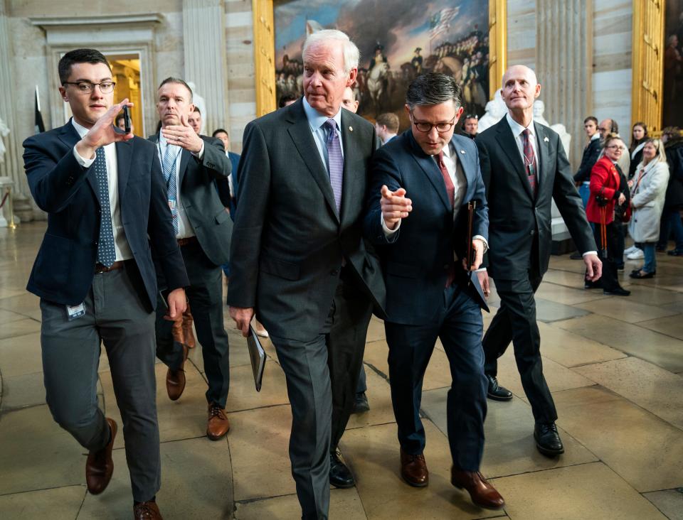 Speaker of the House Mike Johnson (R-LA) (center) walks through the United States Capitol Rotunda with Senators Ron Johnson (R-WI), left, and Rick Scott (R-FL), right, heading to a meeting with Senators on Wednesday, Nov. 1, 2023.