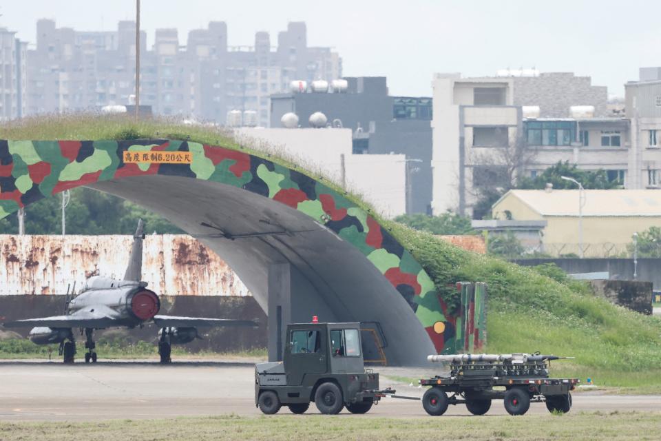 Ground staff members transport missiles near a Taiwan Air Force Mirage 2000-5 aircraft at Hsinchu Air Base, in Hsinchu (Reuters)