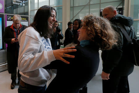 Niki Rahmati, a student at the Massachusetts Institute of Technology (MIT) from Iran, is greeted by immigration attorney Susan Church (R) at Logan Airport after she cleared U.S. customs and immigration on an F1 student visa in Boston, Massachusetts, U.S. February 3, 2017. Rahmati was originally turned away from a flight to the U.S. following U.S. President Donald Trump's executive order travel ban. REUTERS/Brian Snyder