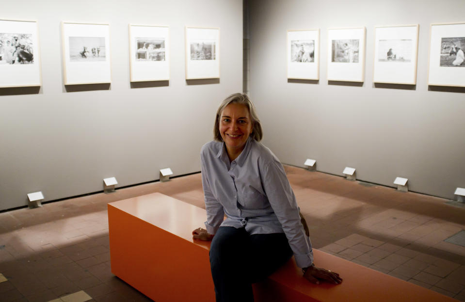 In this Sept. 9, 2011 photo, Associated Press photographer Anja Niedringhaus poses for photographers following a news conference for the opening of her exhibition at the C/O Berlin museum in Berlin. Niedringhaus, 48, an internationally acclaimed German photographer, was killed and an AP reporter was wounded on Friday, April 4, 2014 when an Afghan policeman opened fire while they were sitting in their car in eastern Afghanistan. (AP Photo/David Azia)