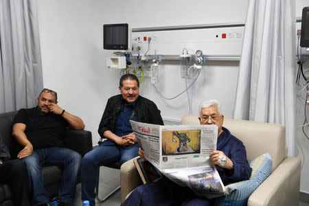 Palestinian President Mahmoud Abbas reads a newspaper inside the hospital in Ramallah, in the occupied West Bank May 21, 2018. Palestinian President Office (PPO)/Handout via REUTERS ATTENTION EDITORS - THIS PICTURE WAS PROVIDED BY A THIRD PARTY. NO RESALES. NO ARCHIVE