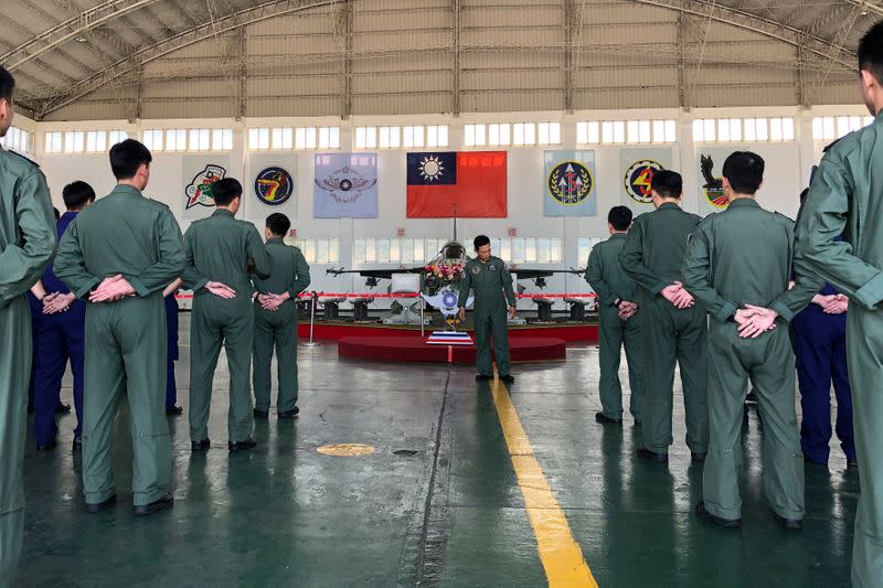 Soldiers gather in front of an Indigenous Defense Fighter (IDF) fighter jet and missiles at Makung Air Force Base in Taiwan's offshore island of Penghu