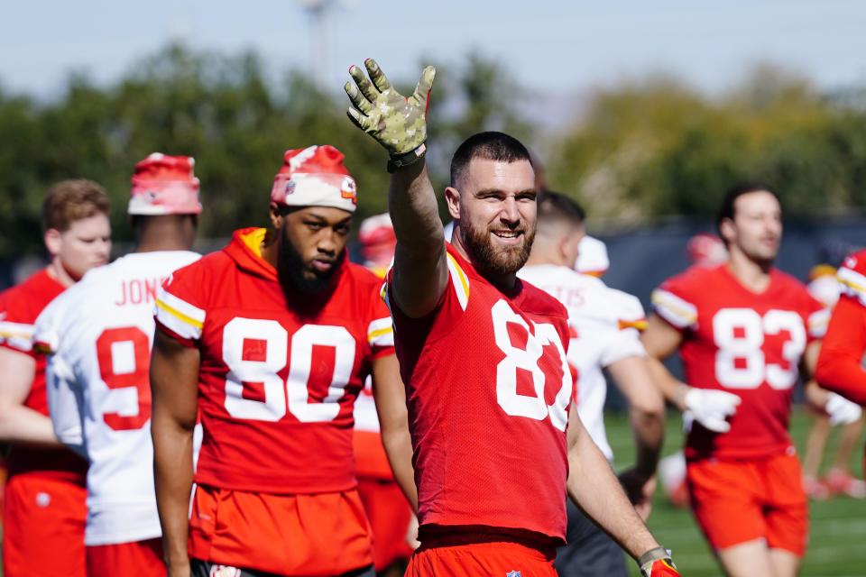 Kansas City Chiefs tight end Travis Kelce (87) waves to the sidelines as he warms up with teammates, including Chiefs tight ends Kendall Blanton (80) Noah Gray (83), during NFL football practice in Tempe, Ariz., Wednesday, Feb. 8, 2023. The Chiefs will play against the Philadelphia Eagles in Super Bowl LVII on Sunday. (AP Photo/Ross D. Franklin)
