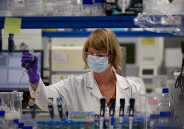 A lab technician conducts research on the novel coronavirus at Johnson & Johnson subsidiary Janssen Pharmaceutical in Beerse, Belgium.  (Virginia Mayo/Associated Press - image credit)