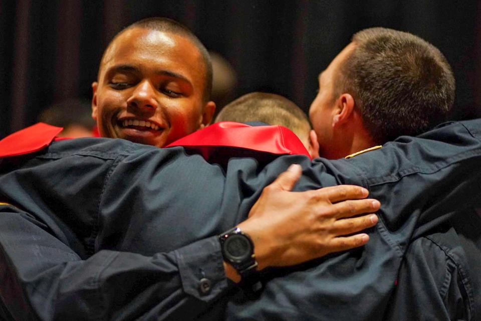 From left, Cadet Kaleb Jones, Cadet Mark Lambert, and Platoon Sergeant Dylan Peltier celebrate at the end of the Michigan Youth Challenge Academy graduation at Marshall High School in Marshall on Saturday, June 15, 2024.