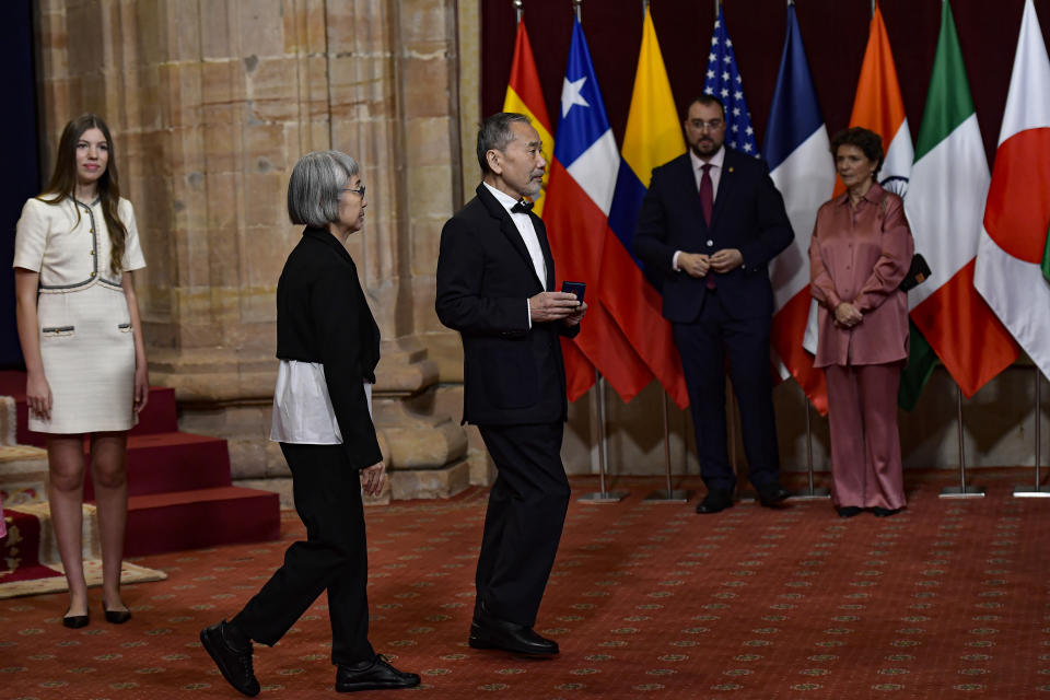 Japanese author Haruki Murakami, right, after receiving an emblem from the Spanish Royal family during the Princess of Asturias awards, in Oviedo, northern Spain, Friday, Oct. 20, 2023. (AP Photo/Alvaro Barrientos)