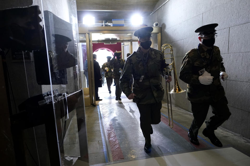 Members of the military band evacuate from the West Front of the U.S. Capitol during a rehearsal the 59th Presidential Inauguration at the U.S. Capitol in Washington, Monday, Jan. 18, 2021. (AP Photo/Carolyn Kaster)