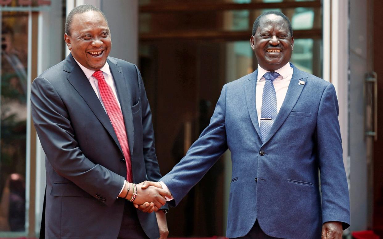 Kenya's President Uhuru Kenyatta (L) greets opposition leader Raila Odinga of the National Super Alliance (NASA) coalition after addressing a news conference at the Harambee house office in Nairobi, Kenya March 9 - REUTERS