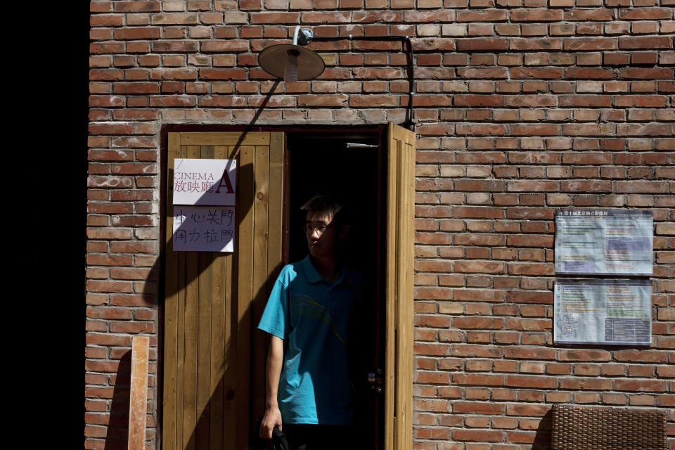 A man walks out of a cinema room where films are shown at the Beijing Independent Film Festival in Beijing, China, Friday, Aug. 30, 2013. Chinese authorities have disrupted an independent film school, shut down two film festivals and harassed organizers of a third in recent months, say independent filmmakers, who see the moves as part of a general clampdown on freedom of expression. (AP Photo/Alexander F. Yuan)