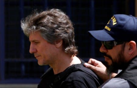 FILE PHOTO: Former Argentine Vice President Amado Boudou is escorted by a member of Argentina's Coastguards as he arrives to a Federal Justice building in Buenos Aires, Argentina November 3, 2017. REUTERS/Martin Acosta