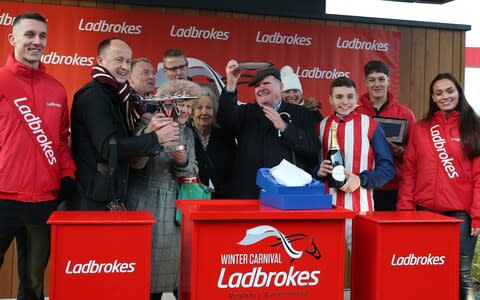 Ben Jones (third right) and trainer Emma Lavelle, Marlborough (fourth right) celebrate at Newbury - Credit: PA