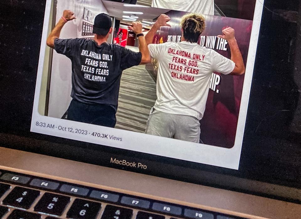 In this screenshot, OU head football coach Brett Venables and OU linebacker Danny Stutsman wear shirts with a photo of Stutsman wearing the Golden Hat trophy taken after the Red River Rivalry game. The back has a Stutsman quote that reads: "Oklahoma fears God. Texas fears Oklahoma."