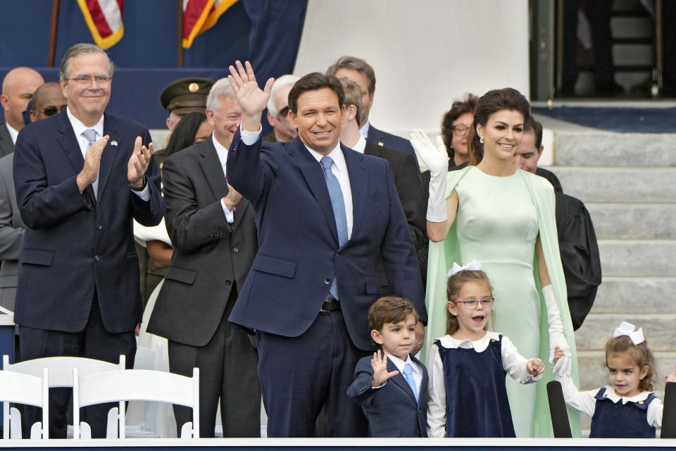 Florida Gov. Ron DeSantis, center, waves as he arrives with his wife Casey, right, and their children Mason, Madison, and Mamie before his inauguration ceremony outside the Old Capitol Tuesday, Jan. 3, 2023, in Tallahassee, Fla. Applauding at a left is former governor Jeb Bush. (AP Photo/Lynne Sladky)