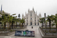 An environmental protest banner, reading "there is no plan(et) B" sits on the edge of an empty Duomo square in view of Duomo Cathedral, in Milan, Italy, on March 10, 2020. (Credit: Camilla Cerea/Bloomberg)